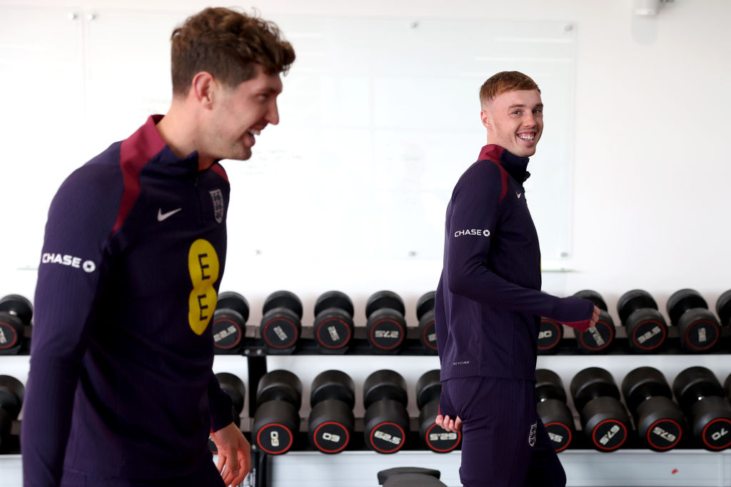 John Stones and Cole Palmer of England interact in the gym at St George's Park on October 07, 2024 in Burton upon Trent, England.