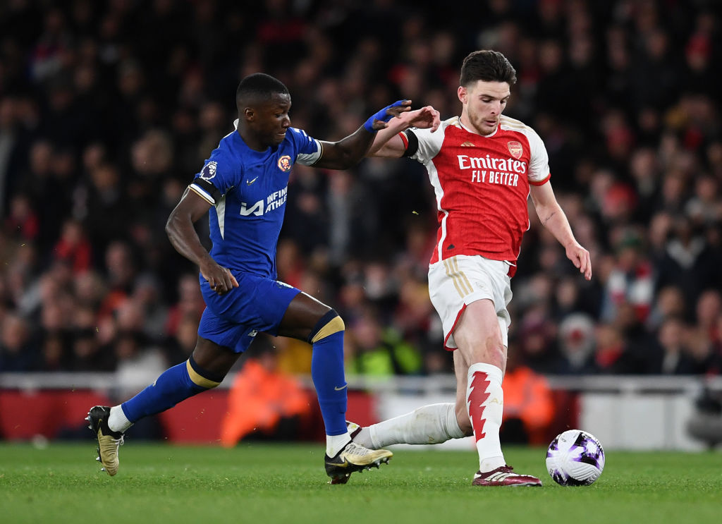 Declan Rice of Arsenal takes on Moses Caicedo of Chelsea during the Premier League match between Arsenal FC and Chelsea FC at Emirates Stadium on A...
