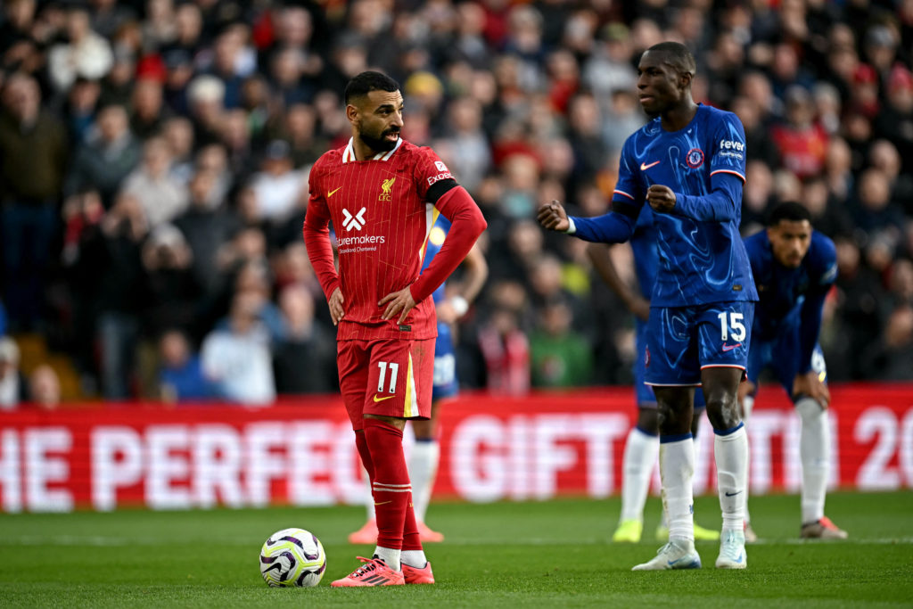 Chelsea's Senegalese striker #15 Nicolas Jackson (R) attempts to distract Liverpool's Egyptian striker #11 Mohamed Salah before being given a yello...
