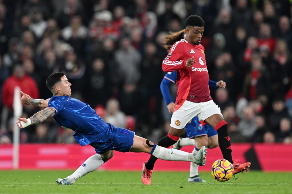 Amad Diallo of Manchester United is challenged by Enzo Fernandez of Chelsea during the Premier League match between Manchester United FC and Chelse...