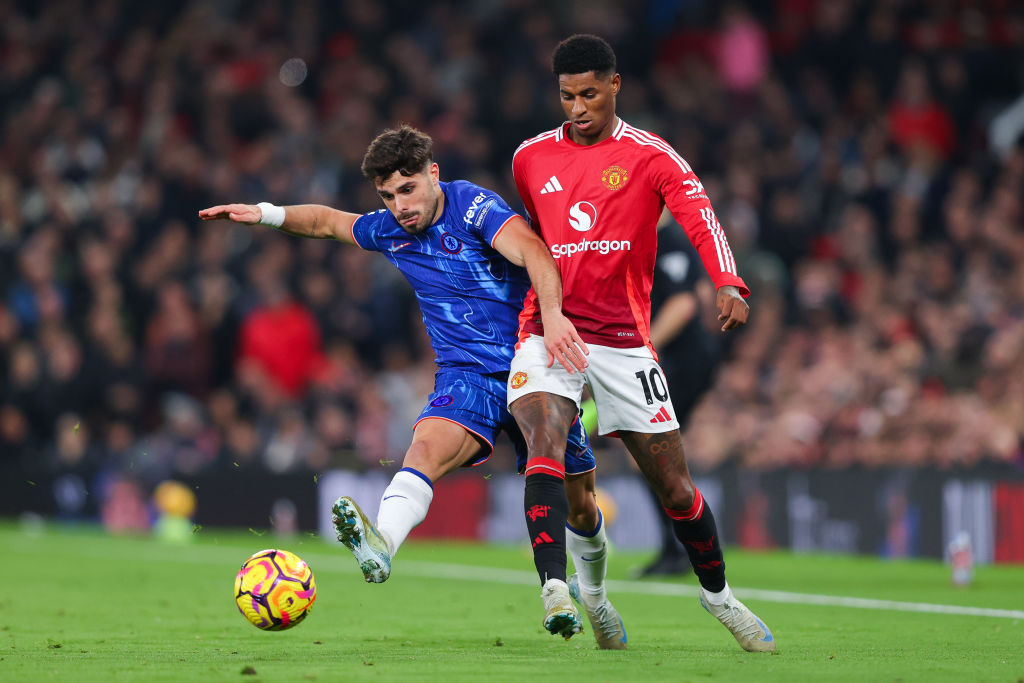 Marcus Rashford of Manchester United battles for possession with Pedro Neto of Chelsea during the Premier League match between Manchester United FC...