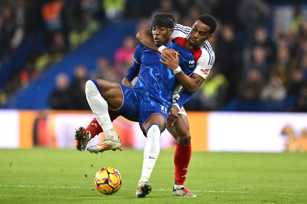 Noni Madueke of Chelsea is fouled by Jurrien Timber of Arsenal during the Premier League match between Chelsea FC and Arsenal FC at Stamford Bridge...