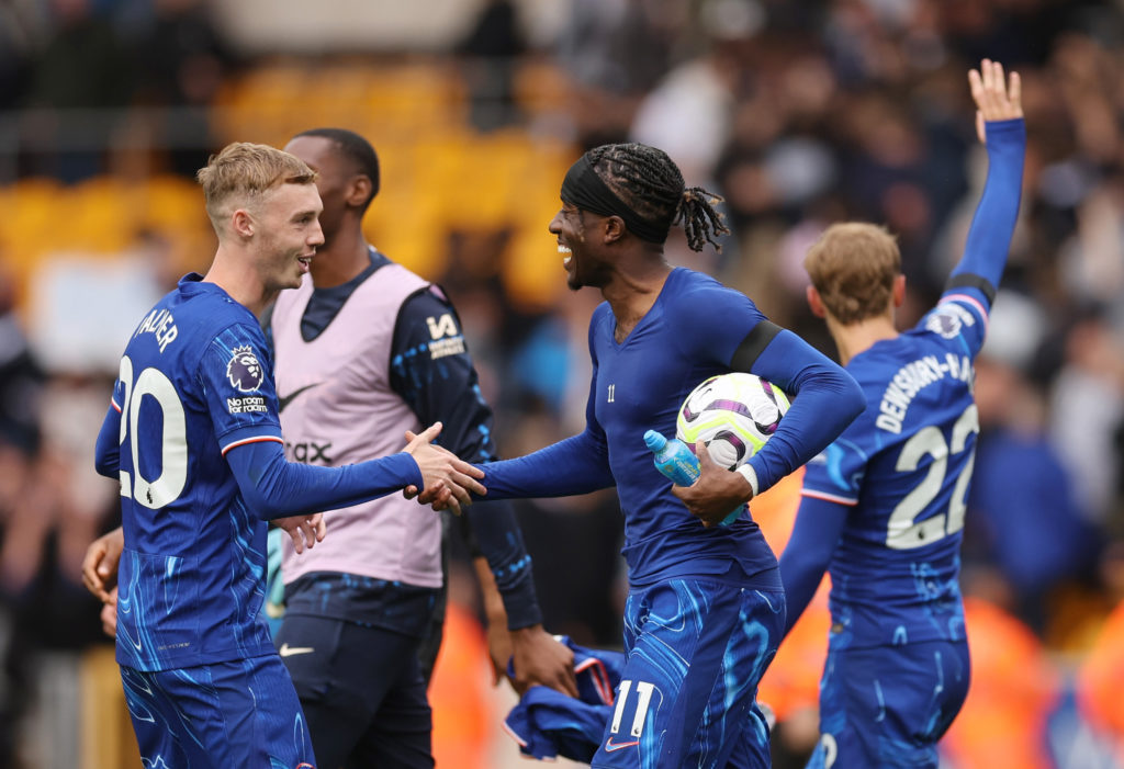 Noni Madueke of Chelsea with the match ball after scoring a hat-trick celebrates with Cole Palmer of Chelsea after the Premier League match betwee...