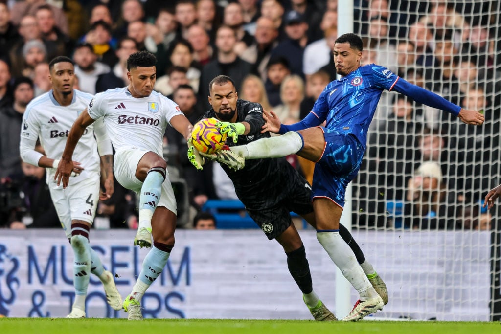 Robert Sanchez and Levi Colwill of Chelsea clear from Ollie Watkins of Aston Villa during the Premier League match between Chelsea FC and Aston Vil...