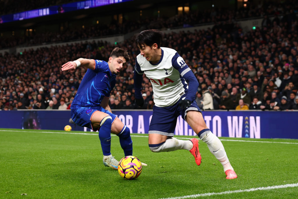 Son Heung-Min of Tottenham Hotspur runs with the ball under pressure from Pedro Neto of Chelsea during the Premier League match between Tottenham H...