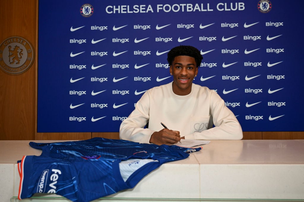 Josh Acheampong of Chelsea signs a new contract at Chelsea Training Ground on December 18, 2024 in Cobham, England.