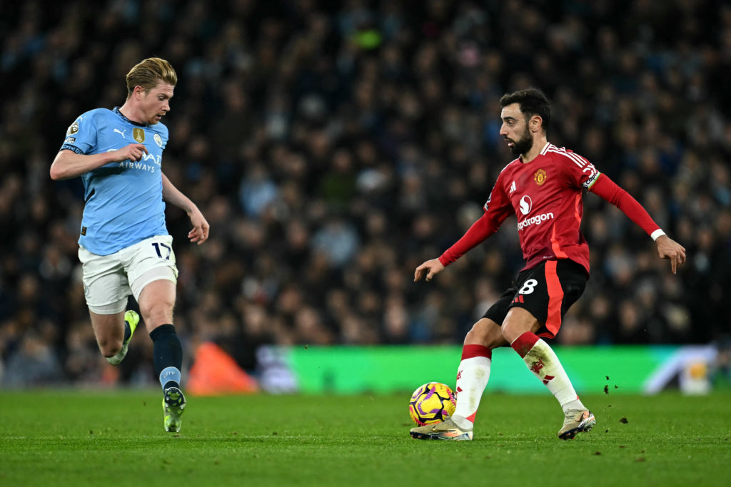 Manchester United's Portuguese midfielder #08 Bruno Fernandes battles for the ball with Manchester City's Belgian midfielder #17 Kevin De Bruyne du...