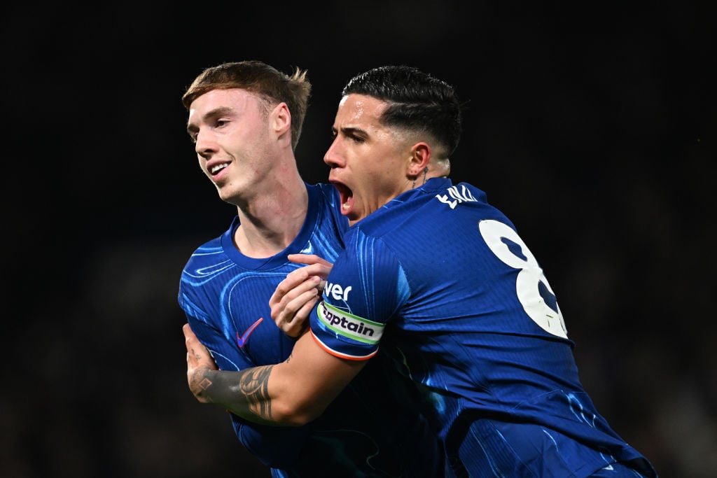 Cole Palmer of Chelsea celebrates scoring his team's first goal with teammate Enzo Fernandez during the Premier League match between Chelsea FC an...