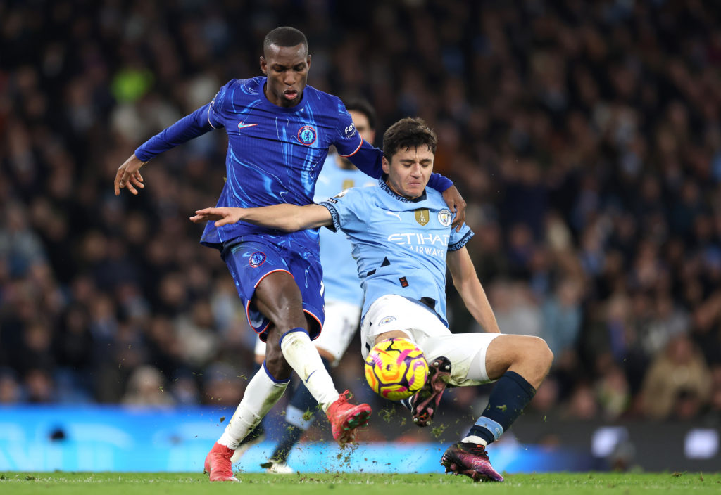 Abdukodir Khusanov of Manchester City is challenged by Nicolas Jackson of Chelsea during the Premier League match between Manchester City FC and Ch...