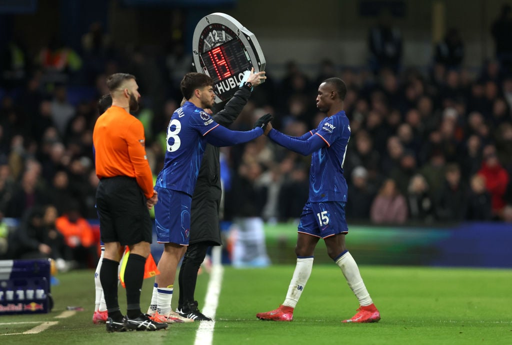 Nicolas Jackson of Chelsea (R) is substituted for teammate Marc Guiu during the Premier League match between Chelsea FC and West Ham United FC at S...