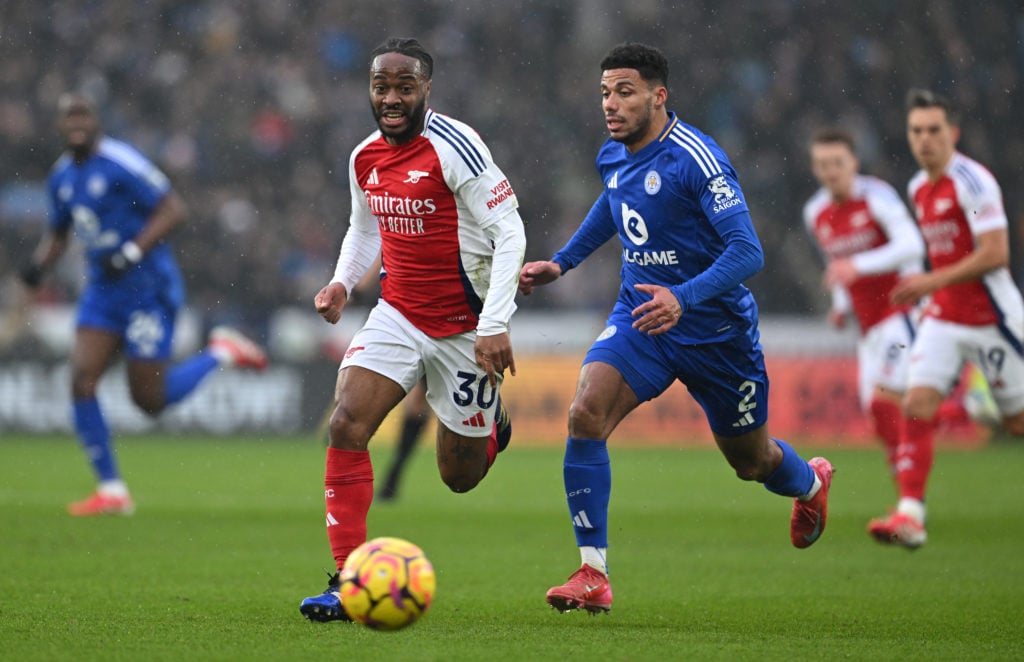 James Justin of Leicester City battles for possession with Raheem Sterling of Arsenal during the Premier League match between Leicester City FC and...