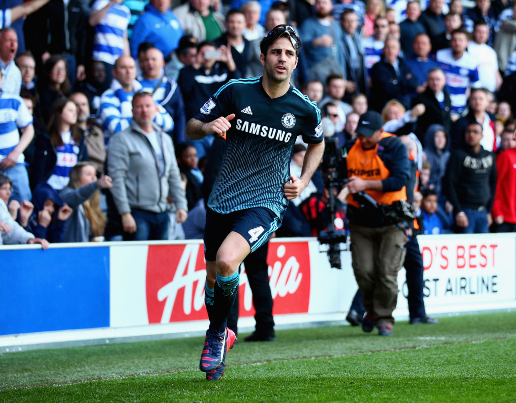 Cesc Fabregas of Chelsea celebrates scoring the opening goal during the Barclays Premier League match between Queens Park Rangers and Chelsea at Lo...