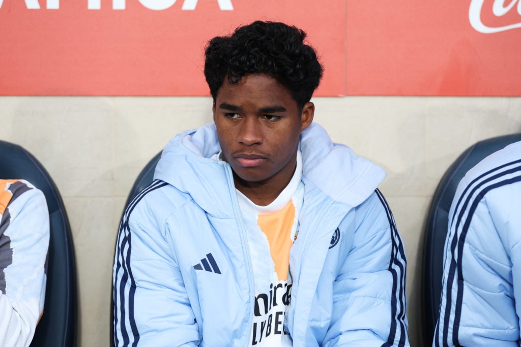 Real Madrid forward Endrick sitting on the bench
