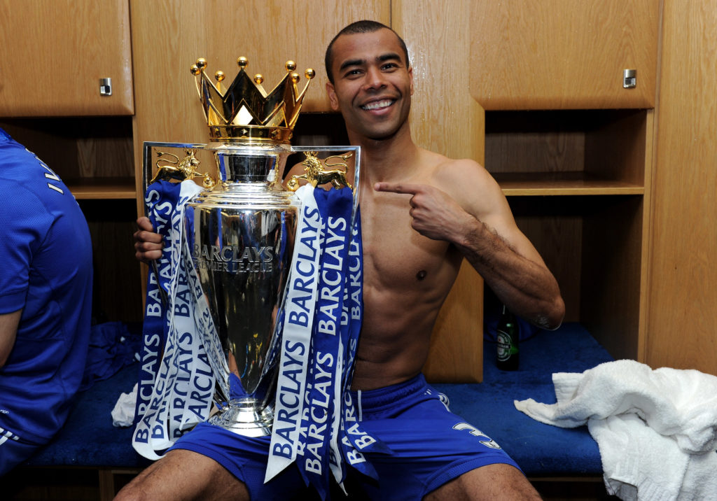 Chelsea legend Ashley Cole holding Premier League trophy