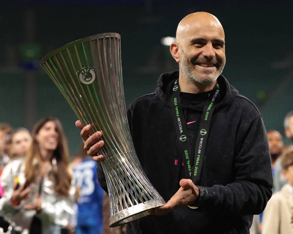 Chelsea manager Enzo Maresca holding Conference League trophy