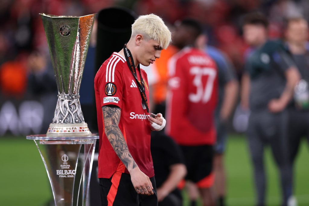 Alejandro Garnacho walks past the trophy after Tottenham Hotspur v Manchester United - UEFA Europa League Final 2025