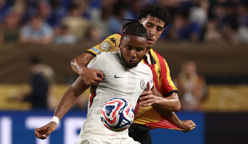 Chelsea's French striker #18 Christopher Nkunku (front) and Esperance's Tunisian midfielder #04 Mohamed Wael Derbali fight for the ball