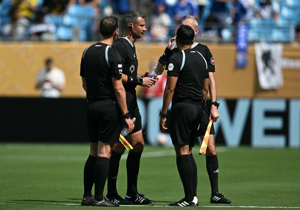 The referees in conversation during Chelsea vs Benfica at the Club World Cup