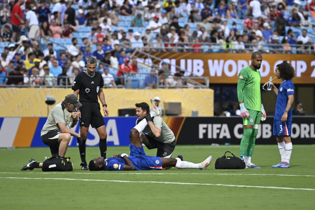 Benoit Badiashile receives treatment during Benfica SL v Chelsea FC: Round Of 16 - FIFA Club World Cup 2025
