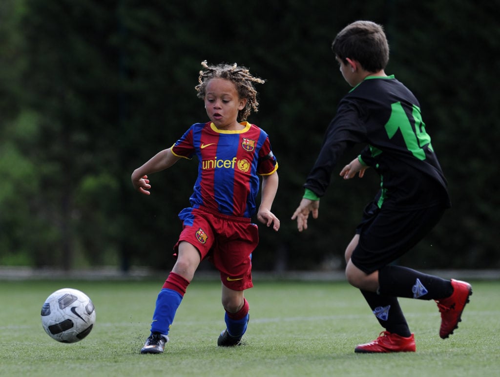 Eight-year-old Barcelona youth player Xavi Simons strikes the ball