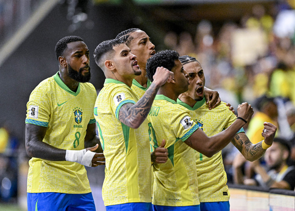 Brazil players, including Rodrygo, celebrating after scoring against Colombia