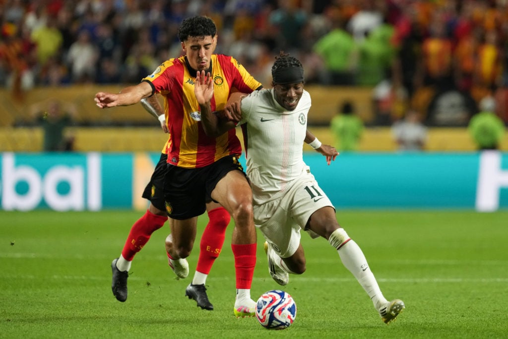 Chelsea winger Noni Madueke dribbling with the ball against ES Tunis player
