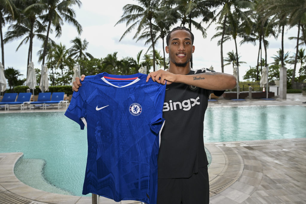 Joao Pedro holding up the Chelsea shirt after being confirmed as a new signing.