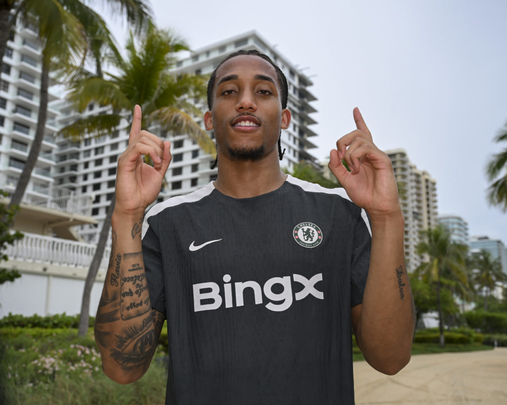 Joao Pedro poses with his hands up after being unveiled as a Chelsea signing.