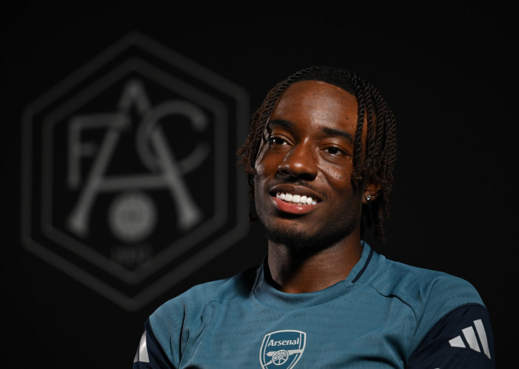 Noni Madueke poses after being confirmed as a new Arsenal player.
