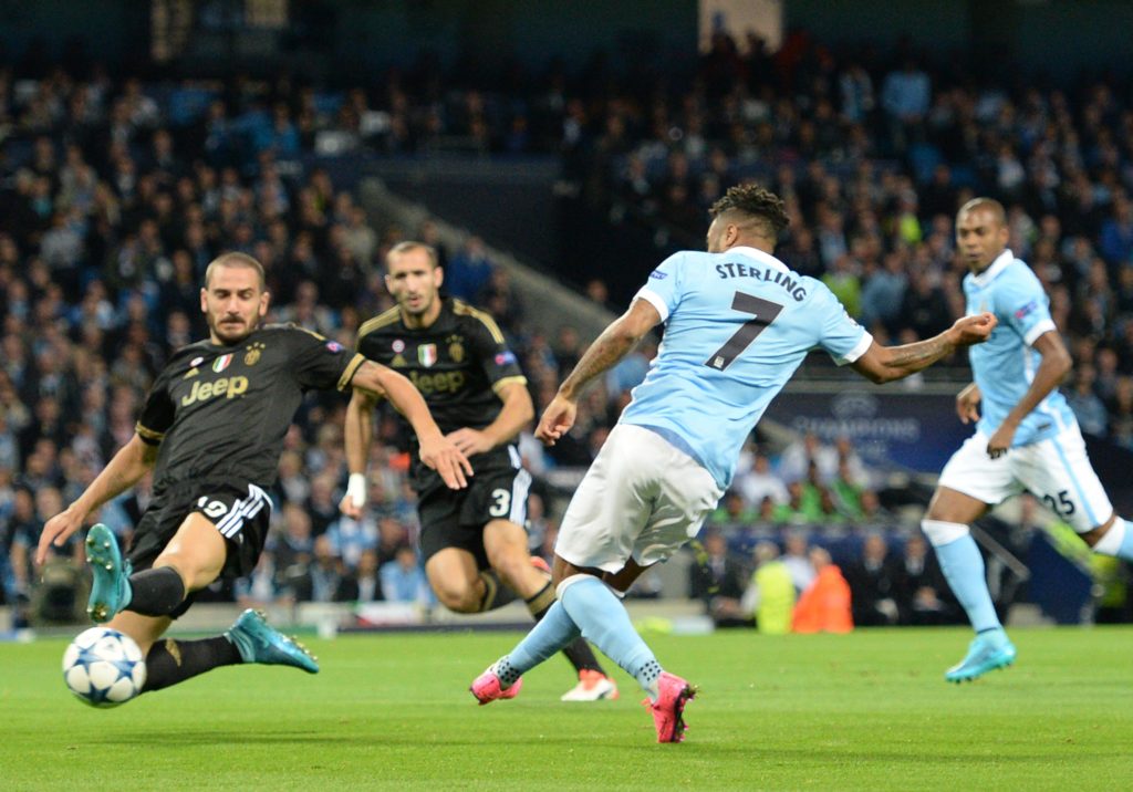 Manchester City's English midfielder Raheem Sterling (R) has a shot on goal
