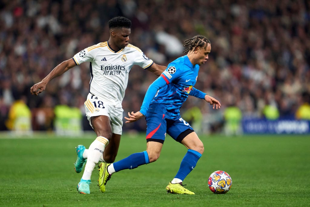 Xavi Simons dribbling against Aurelien Tchouameni during Real Madrid against RB Leipzig in the Champions League.
