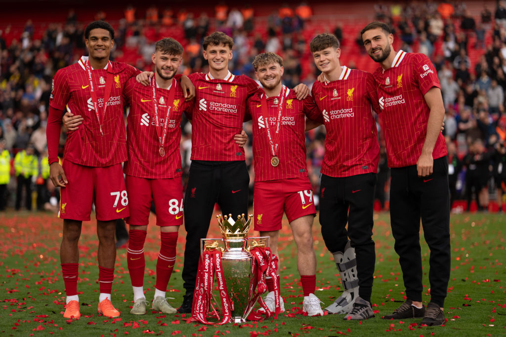 Liverpool players celebrating with Premier League trophy