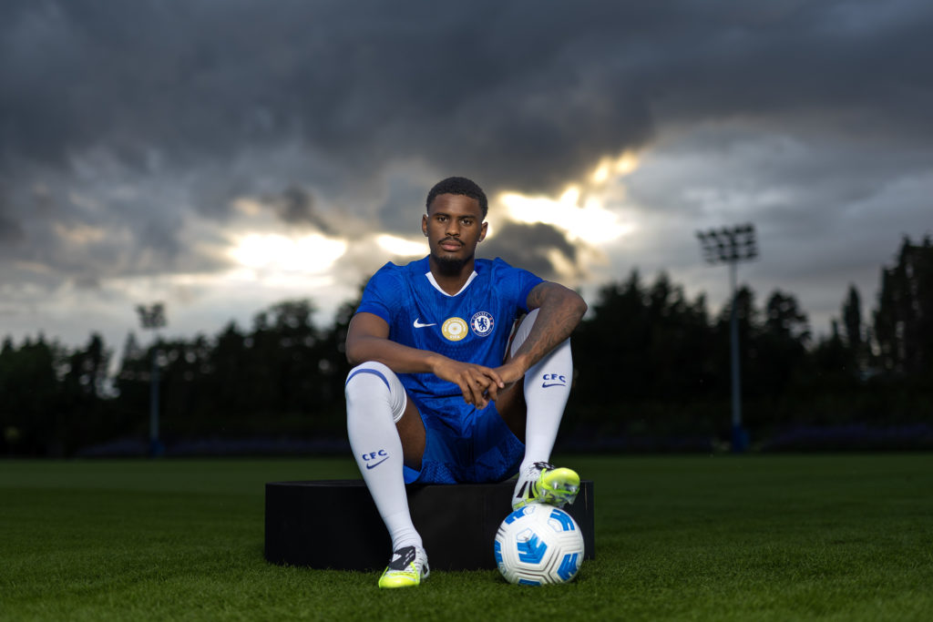 Jorrel Hato poses at the training ground after being confirmed as a Chelsea player.