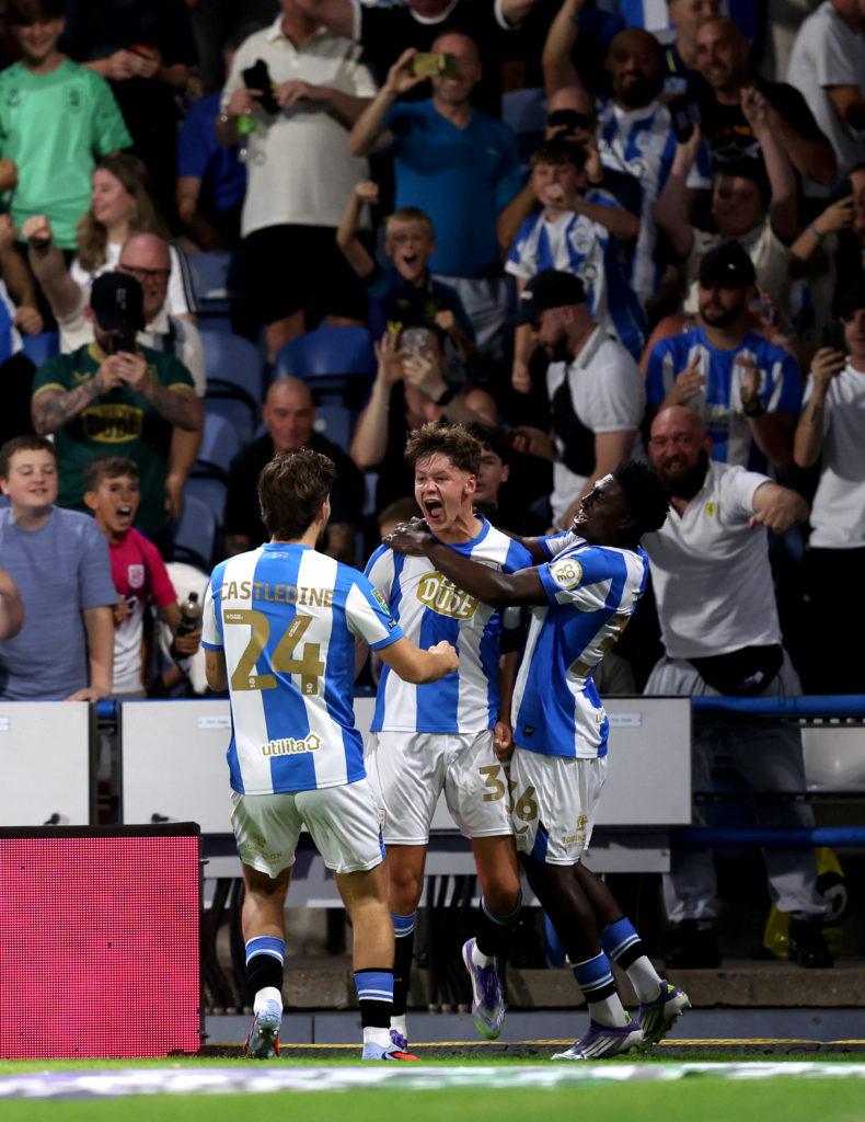 Huddersfield Town players celebrate scoring against Leicester City in the Carabao Cup.