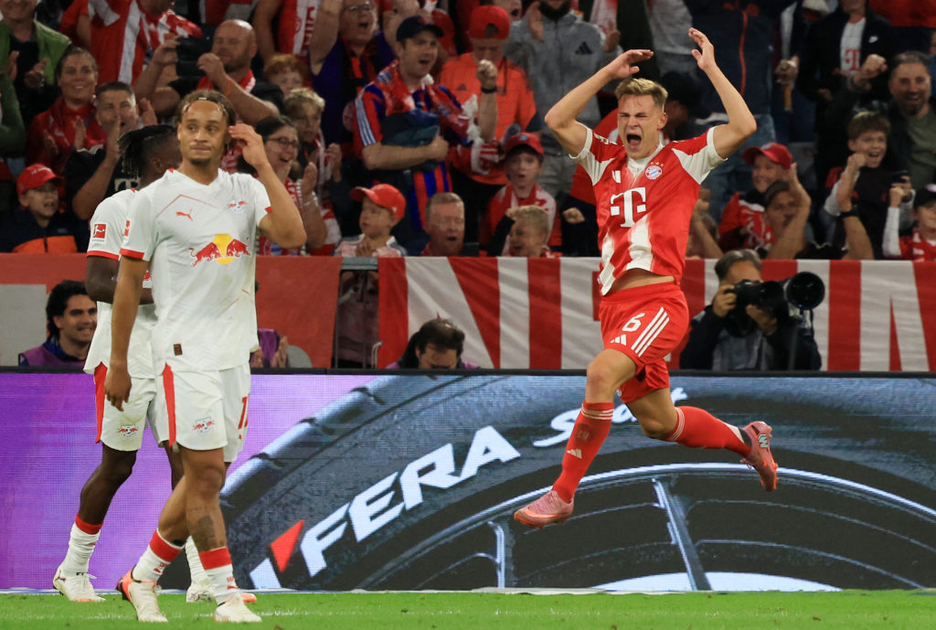 RB Leipzig's Xavi Simons looks on as Joshua Kimich celebrates scoring for Bayern Munich in the Bundesliga.