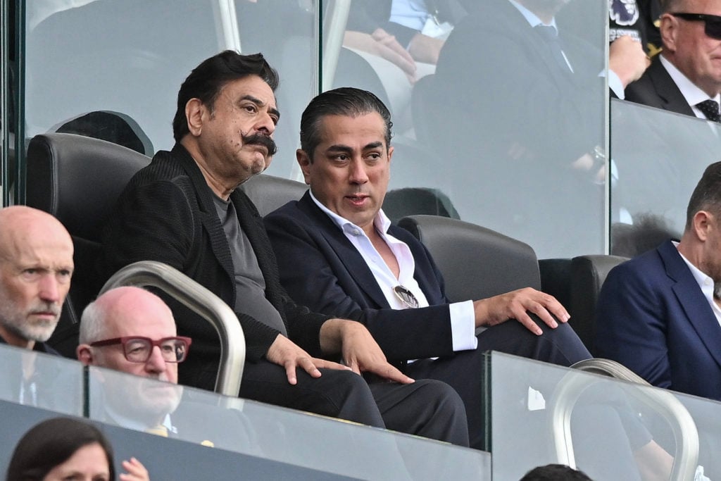 Fulham's Shahid Khan and Chelsea's Behdad Eghbali in conversation at Craven Cottage during a Premier League match.