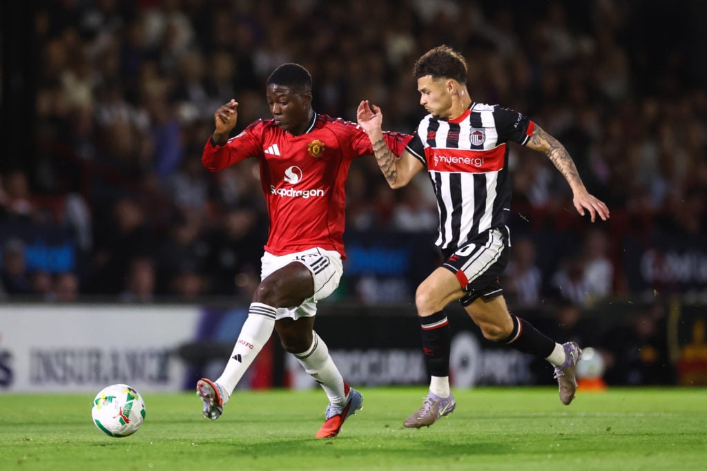George McEachran of Grimsby Town battling against Kobbie Mainoo of Manchester United in a Carabao Cup match.