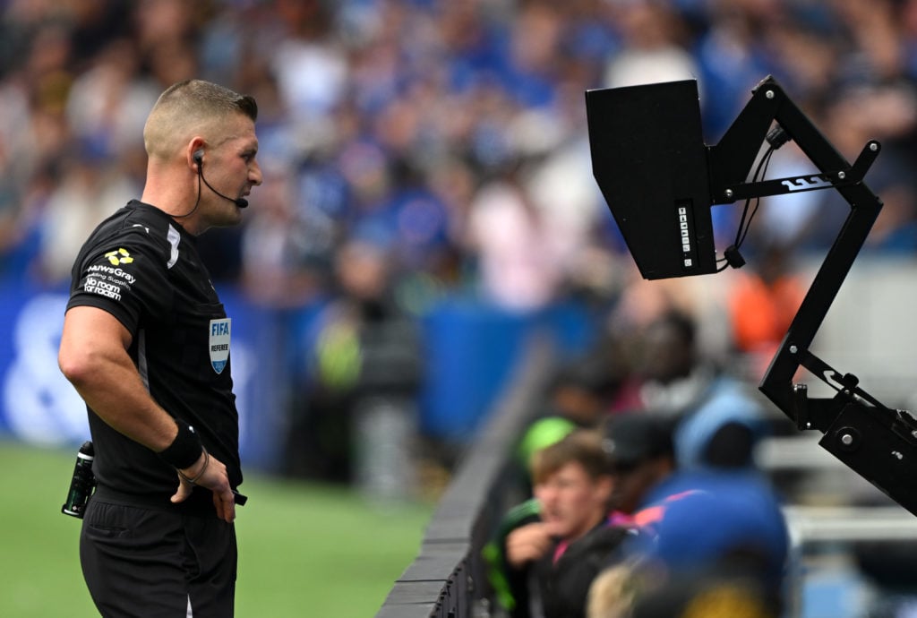 Rob Jones checks VAR for a possible penalty during Chelsea v Fulham - Premier League