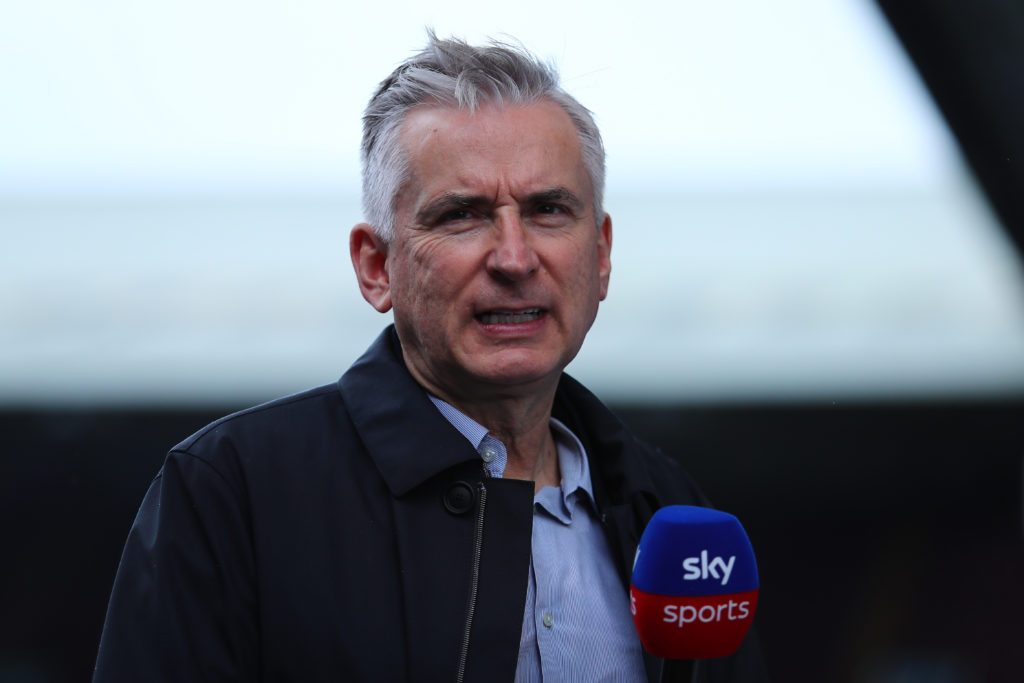 Sky Sports pundit Alan Smith holding microphone