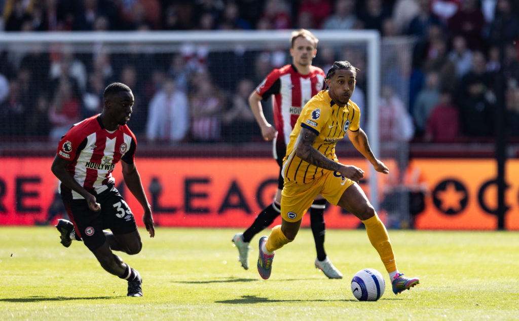 Brighton star Joao Pedro breaks away from Brentford defenders during a Premier League fixture.