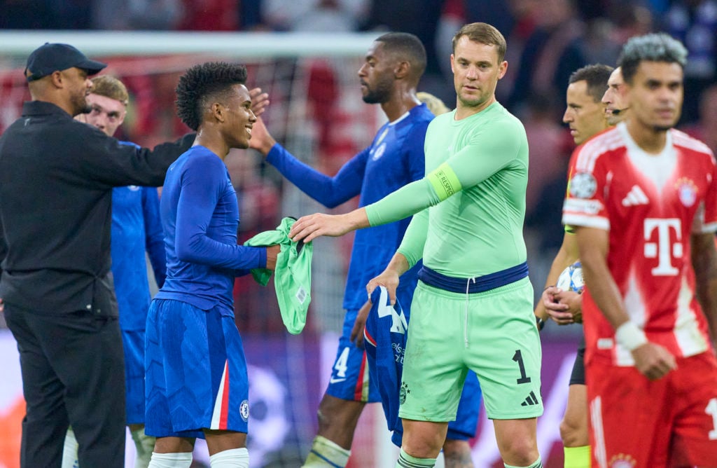 Estevao Willian of Chelsea gets the jersey of Manuel Neuer, goalkeeper of FC Bayern Munich