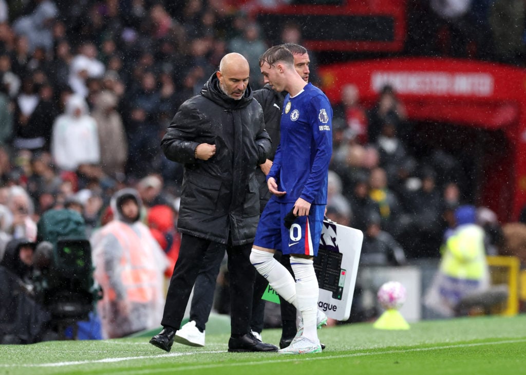 Enzo Maresca and Cole Palmer speak during Chelsea's Premier League match against Manchester United.