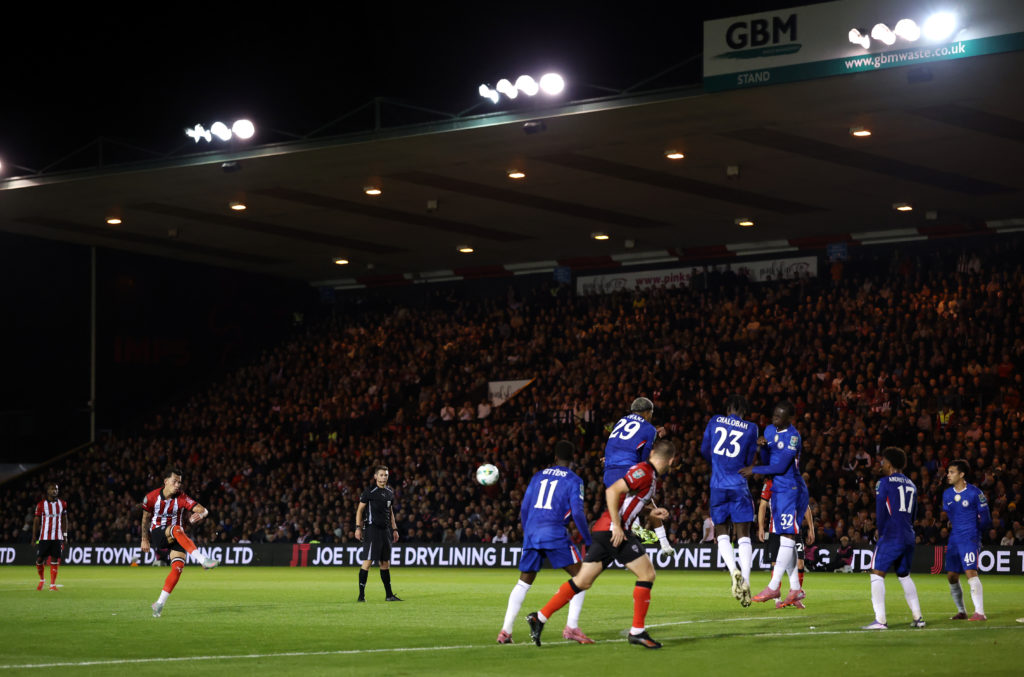 Chelsea players defending Lincoln's free-kick