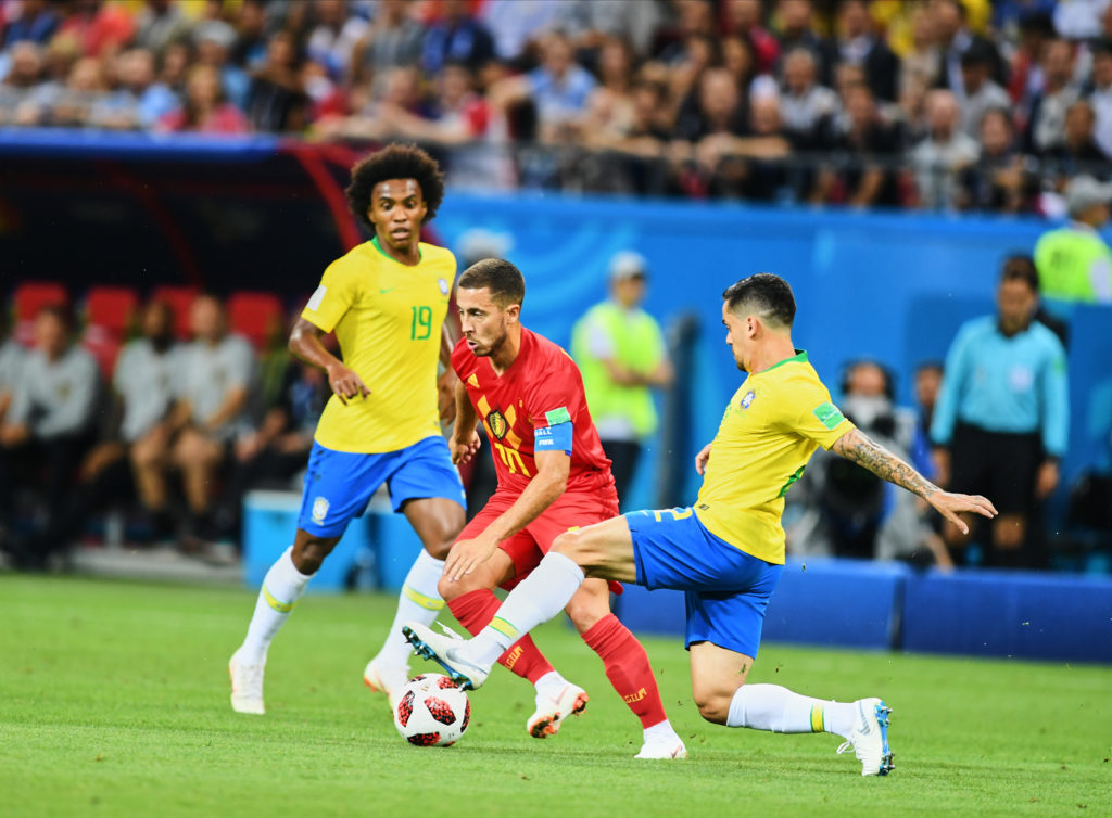 Belgium winger Eden Hazard dribbling past Brazil players