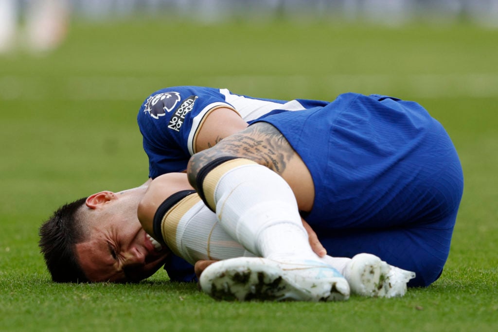 Enzo Fernandez reacts after picking up an injury during Chelsea vs Aston Villa
