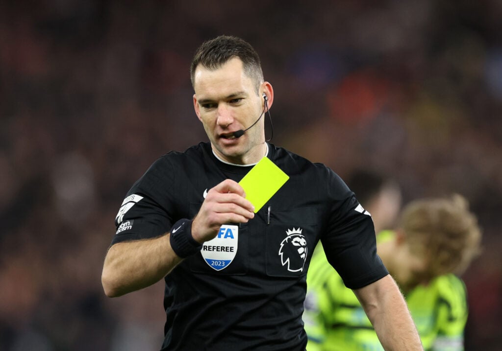 Jarred Gillett issues a yellow card during Aston Villa v Arsenal FC - Premier League