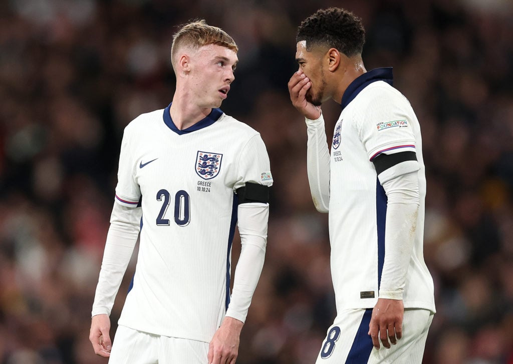 Jude Bellingham talks with Cole Palmer during England's match against Greece in the Nations League.