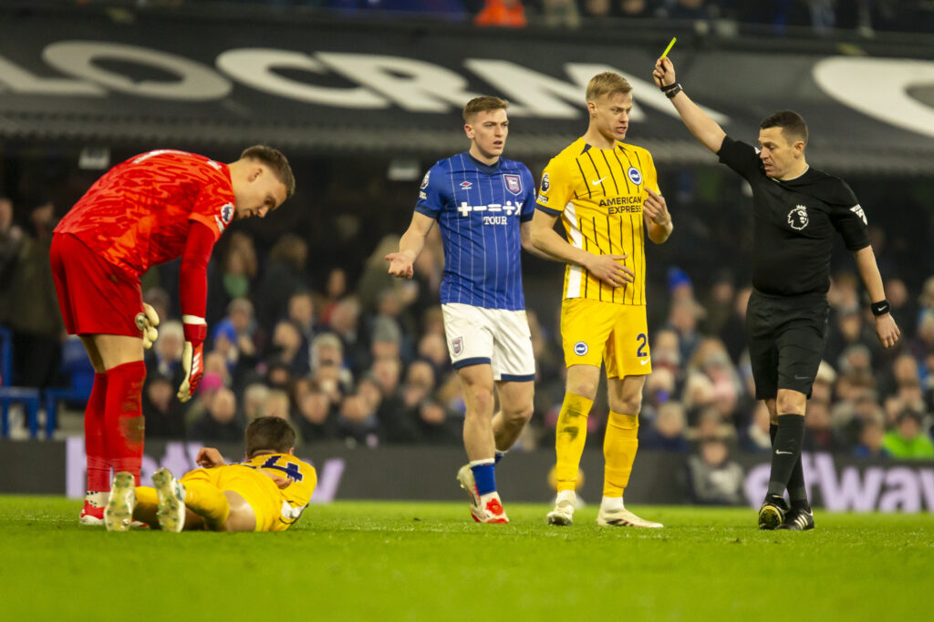 Ipswich Town striker Liam Delap is shown a yellow