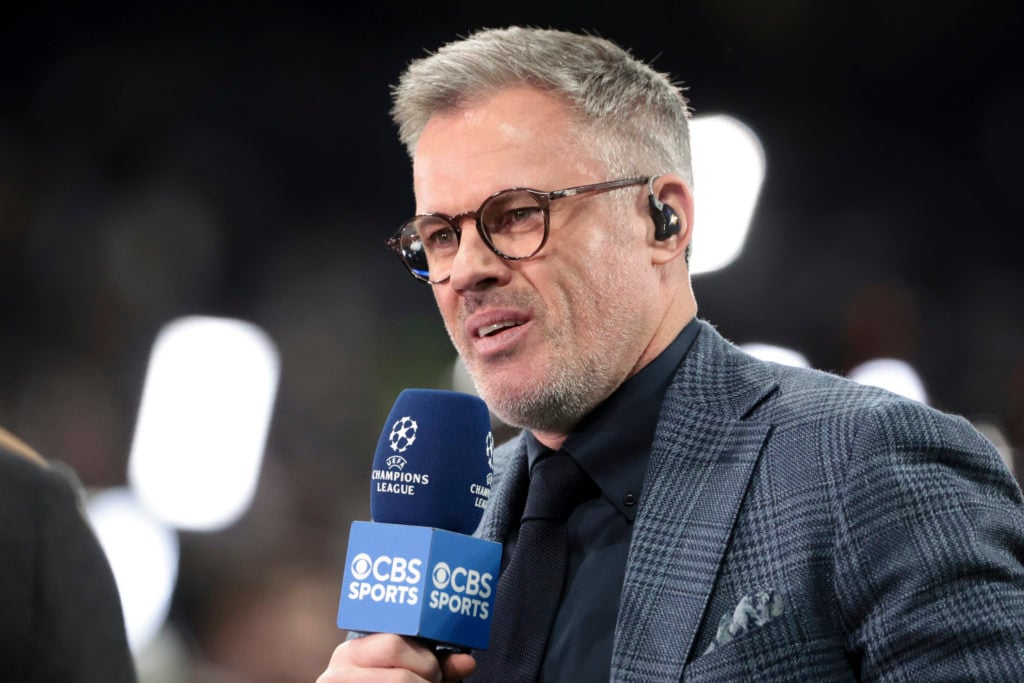Liverpool legend and pundit Jamie Carragher holding microphone