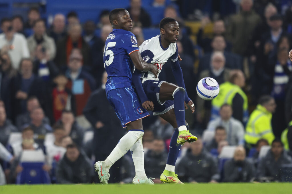 Chelsea midfielder Moises Caicedo battling against Tottenham midfielder Pape Matar Sarr in a Premier League match.